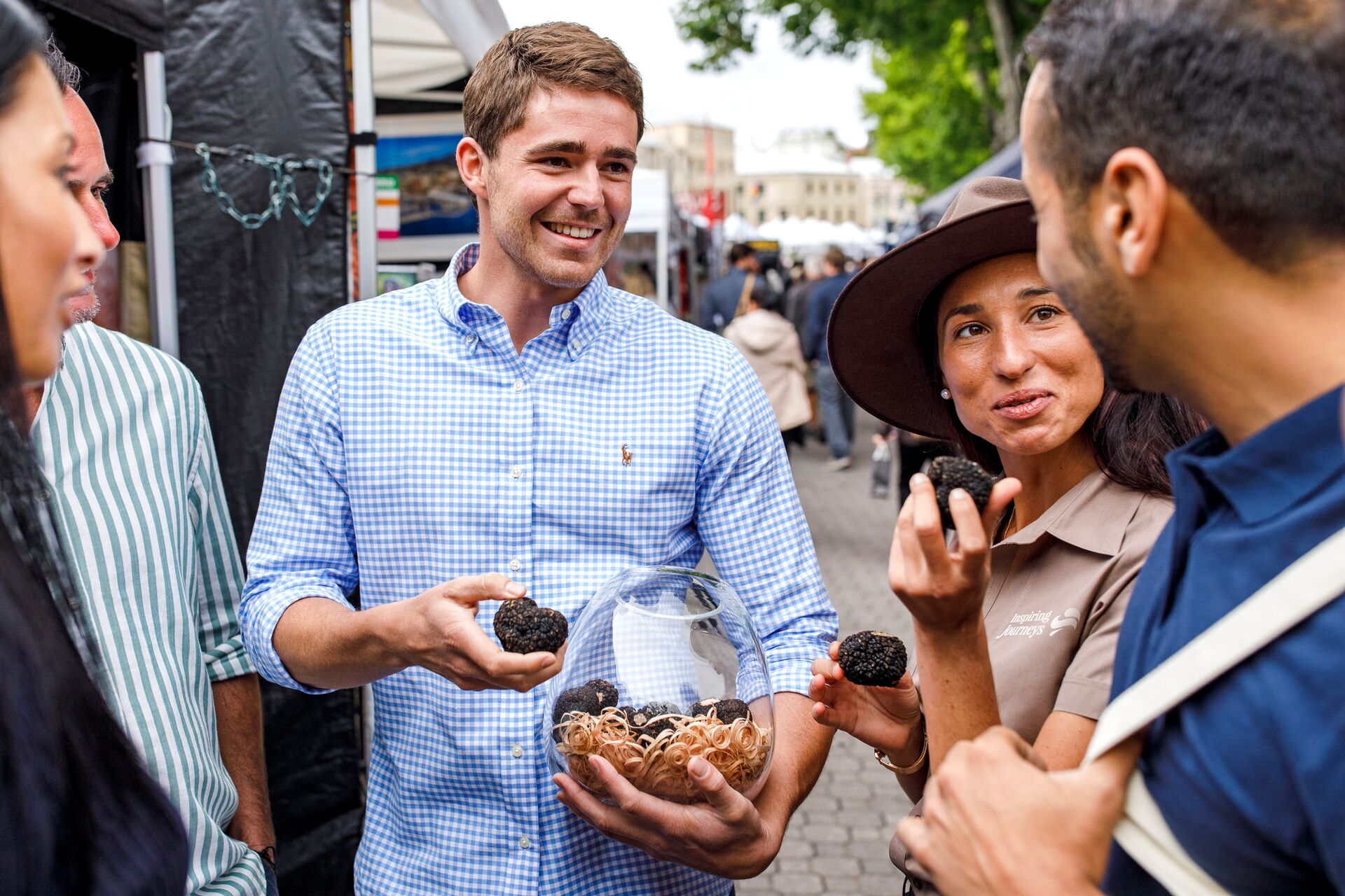 A group of tourists buying truffels in Salamanca Market in Hobart, Tasmania