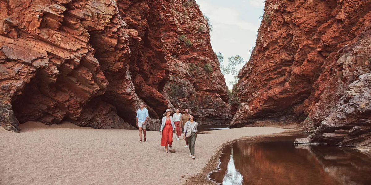 A group of people walking into Simpsons Gap