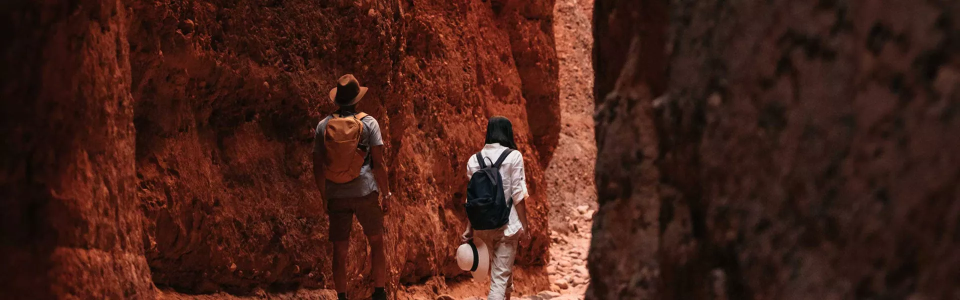 Two people walking through canyon