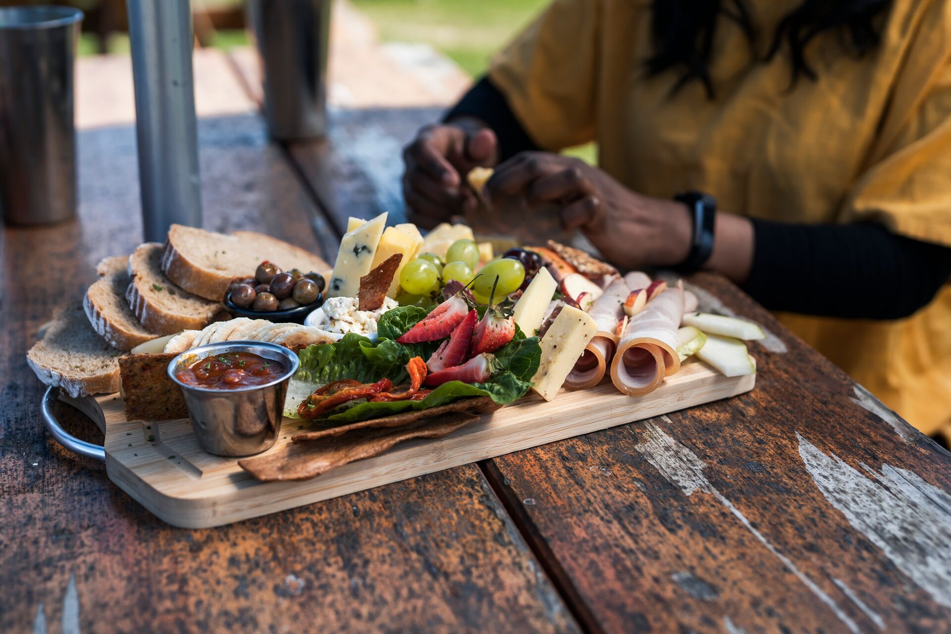 A person sitting at a table with a plate of food